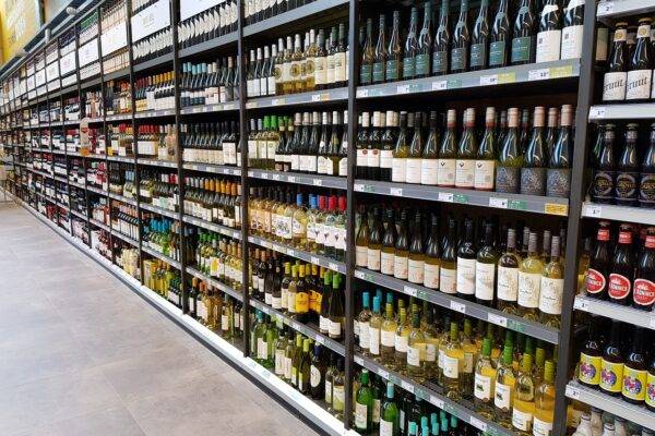 A photo of the wine aisle in a supermarket.