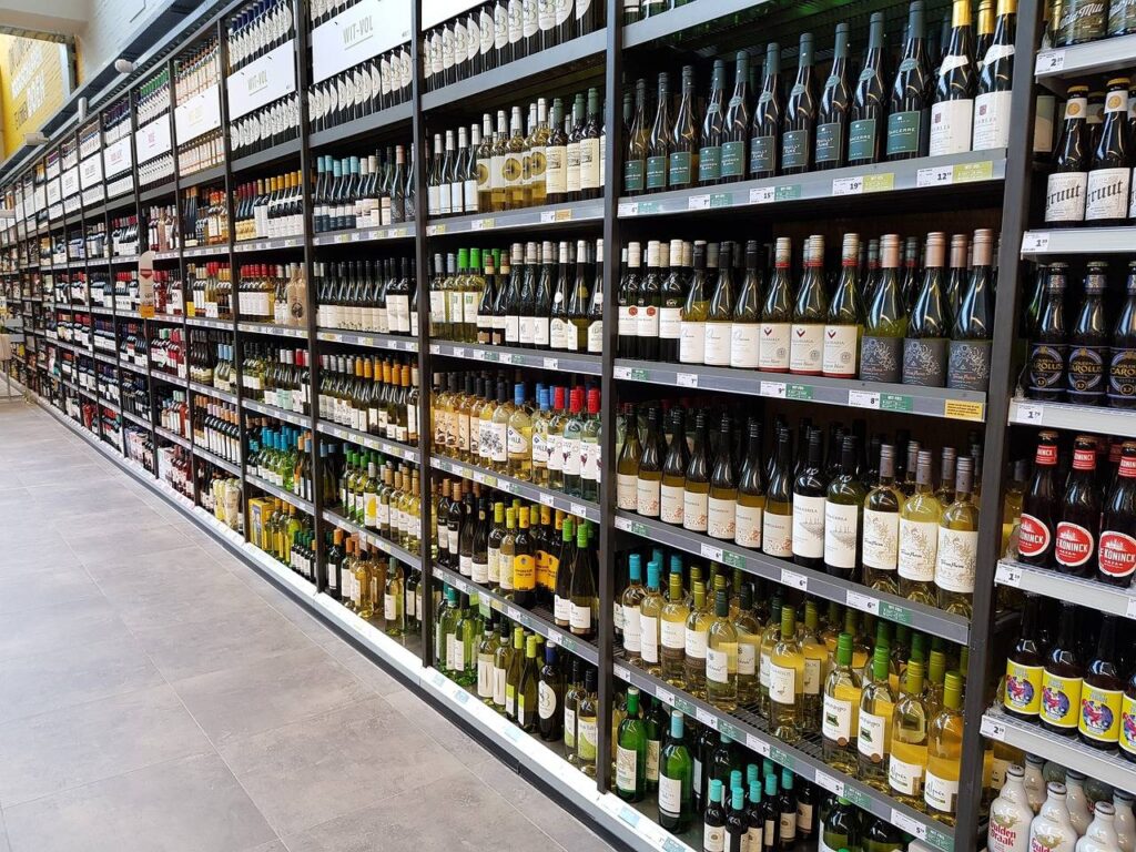A photo of the wine aisle in a supermarket.