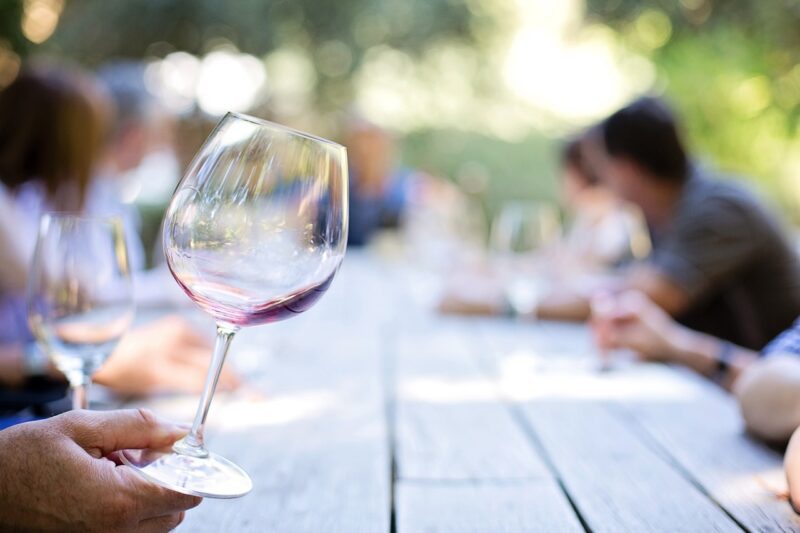 A wine critic holding a wine glass.