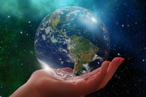 A photo of a hand holding a globe.