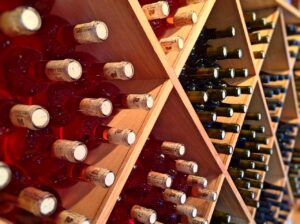 A photo of many wine bottles in a shelf.