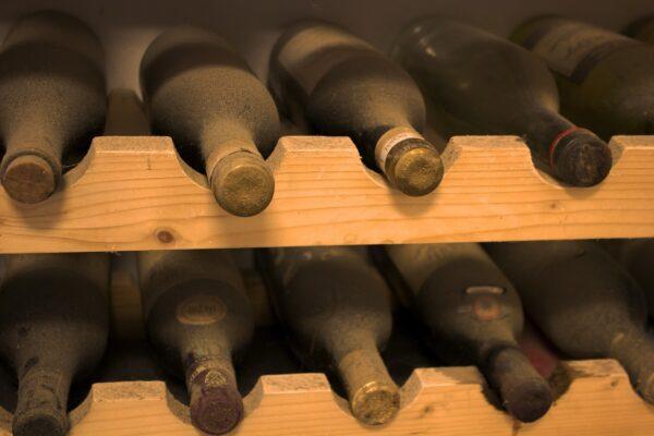 A photo of dusty wine bottles in a wine cellar.