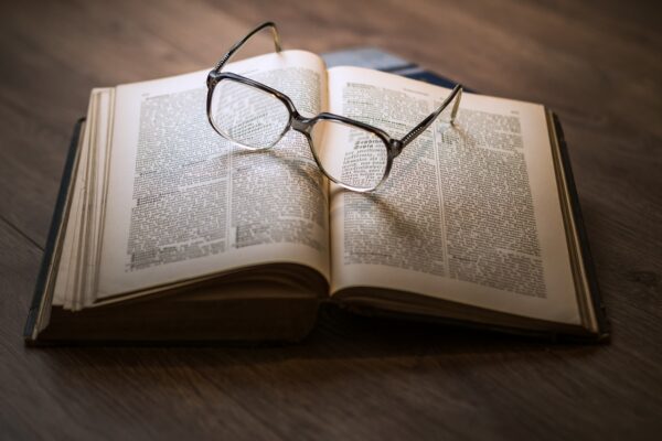 A photo of a book with glasses op top.