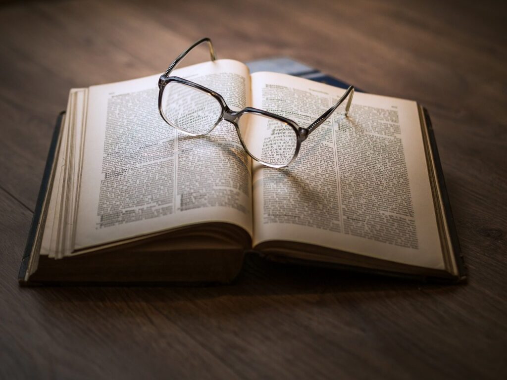 A photo of a book with glasses op top.