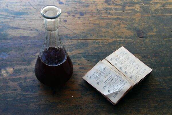 Photo of a decanter and a book, wine history.