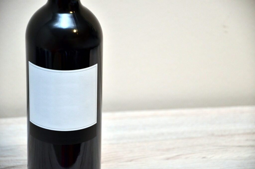 A photo of a wine bottle with a blank label.
