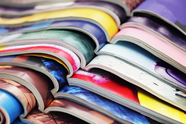 A photo of a lot of colorful magazines.