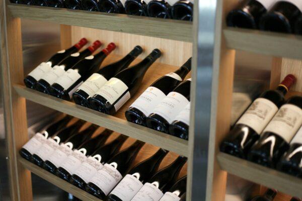 A photo of wine bottles in a wooden rack.